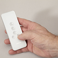 Photo of hand holding an Automated Blinds remote control