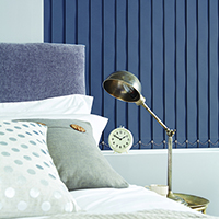 Photo of blue-grey vertical blinds in bedroom